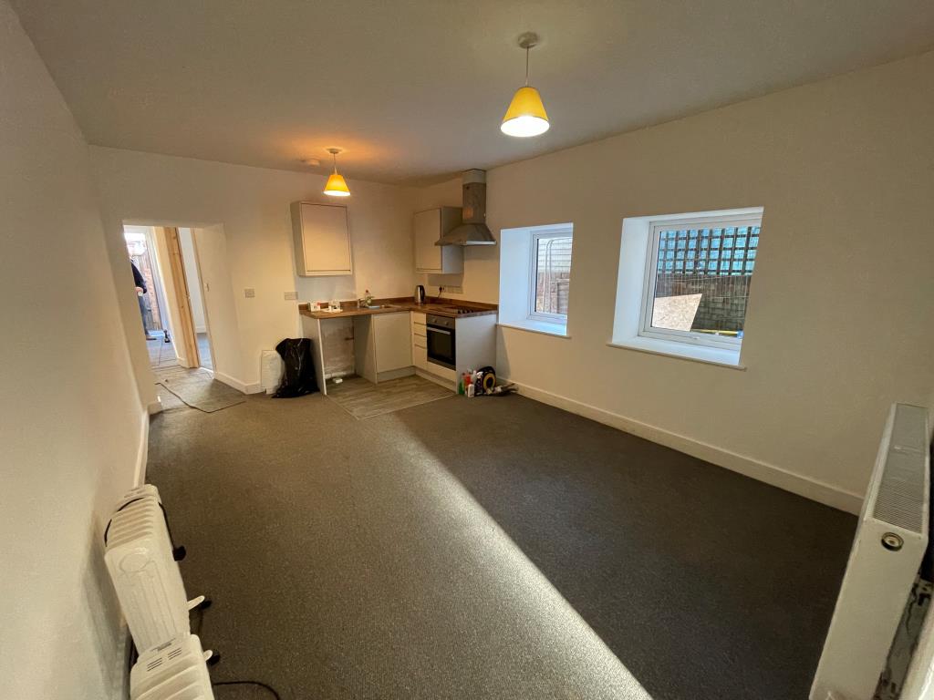 Lot: 125 - RECENTLY EXTENDED PROPERTY ARRANGED AS FIVE WELL PRESENTED FLATS - Living room with kitchen